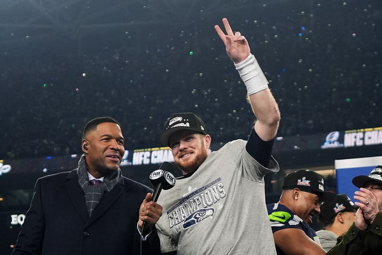 Seattle Seahawks quarterback Sam Darnold, celebrates next to Michael...