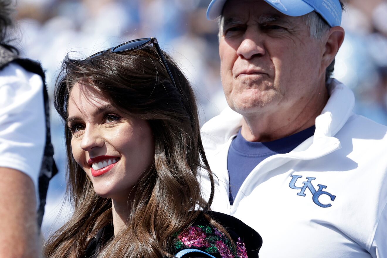 North Carolina head coach Bill Belichick, right, and his girlfriend...