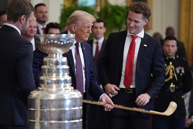 President Donald Trump holds a hockey stick presented to him by Matthew Tkachuk during an event to honor the 2025 Stanley Cup Champion Florida Panthers