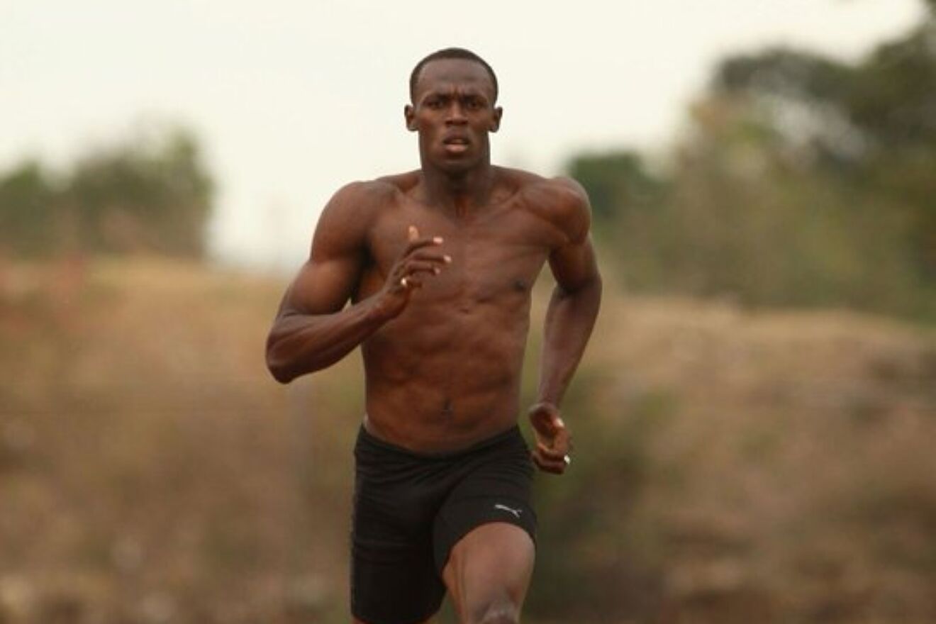 Usain Bolt running shirtless.