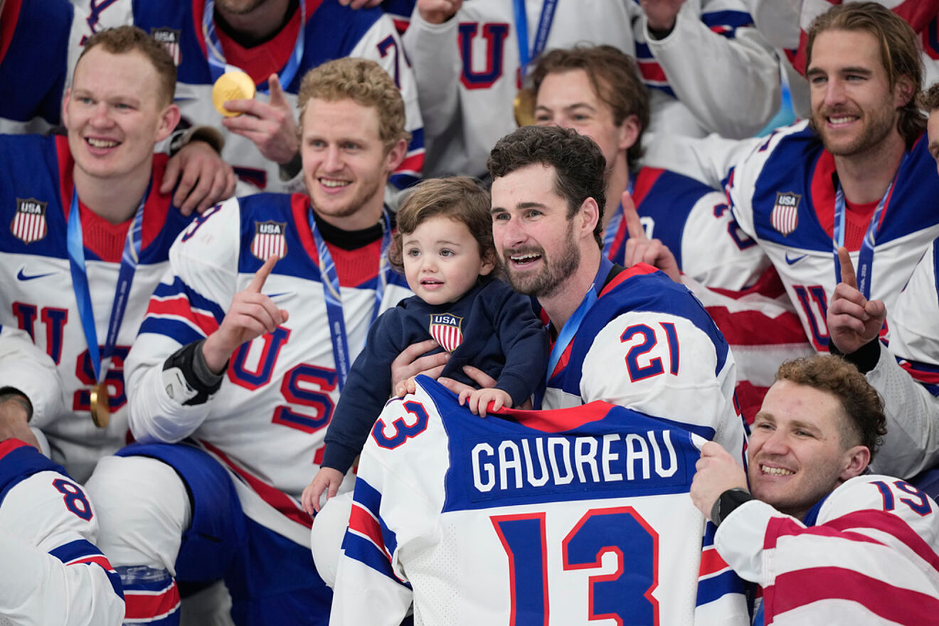 United States' Dylan Larkin holds Johnny, the son of the late player...