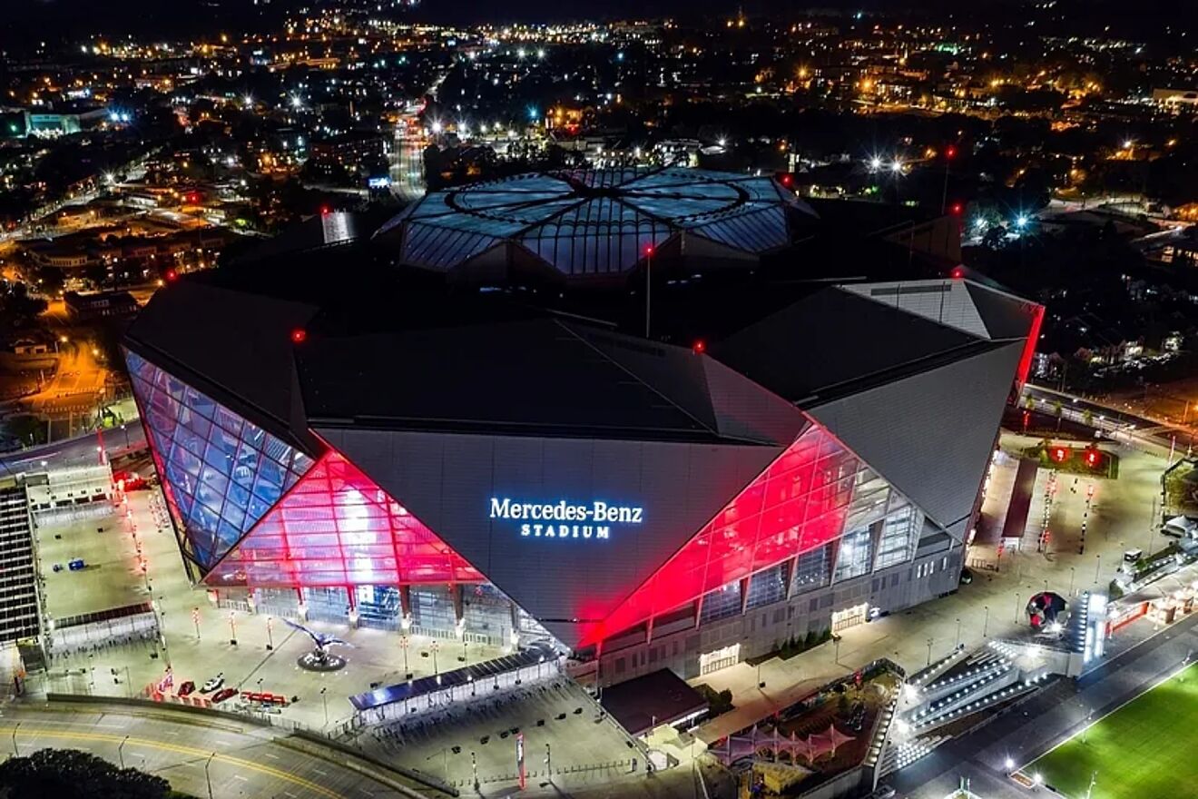 A nighttime aerial view of the Mercedes-Benz Stadium.