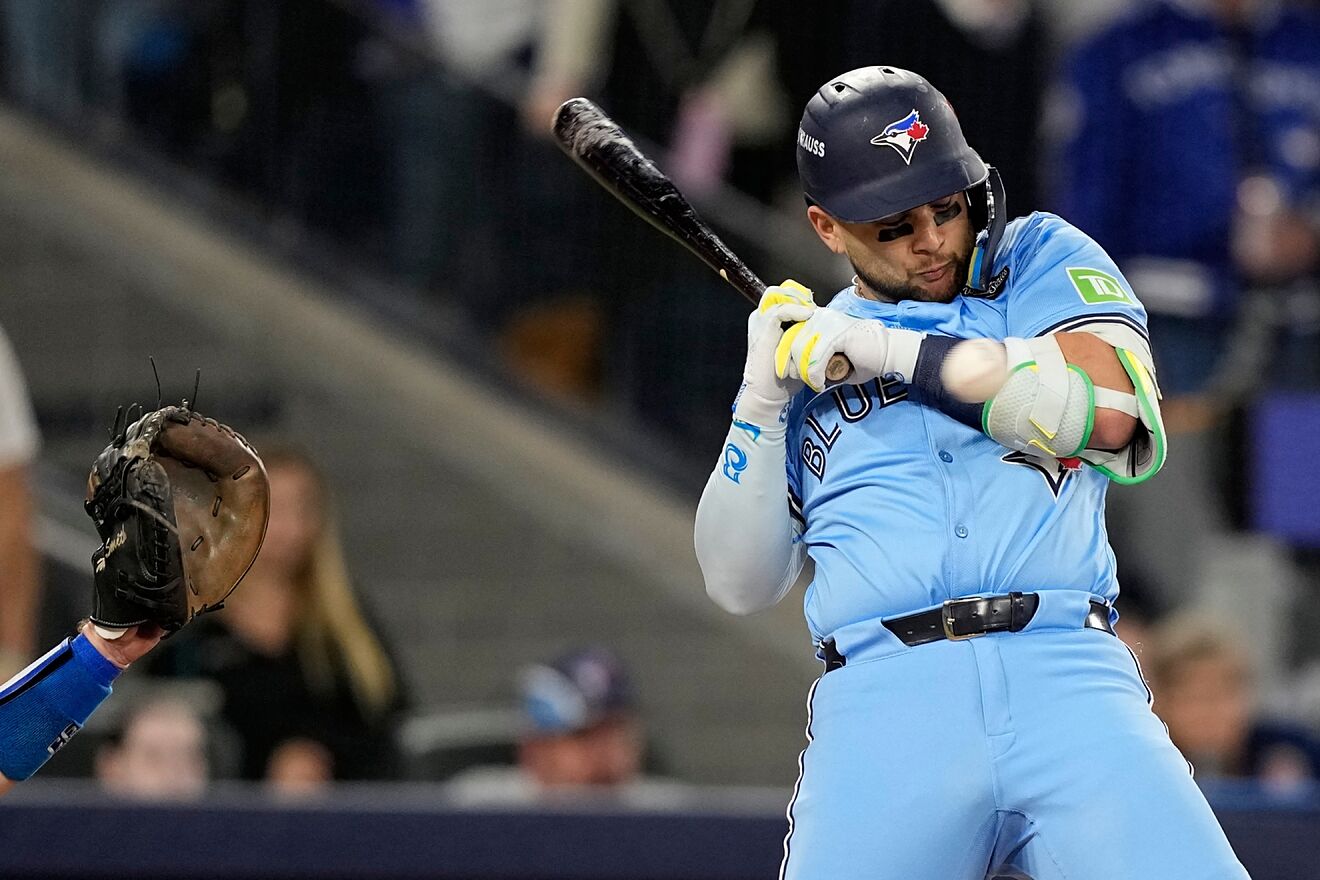 Toronto Blue Jays' Bo Bichette gets hit by a pitch.