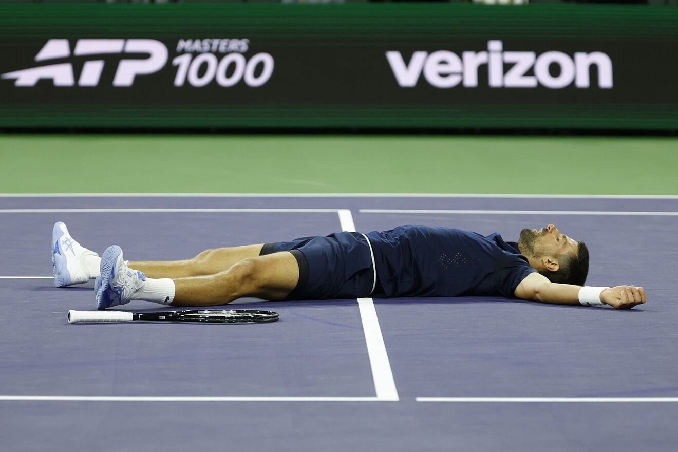 Djokovic, lying on the court during his match with Draper.