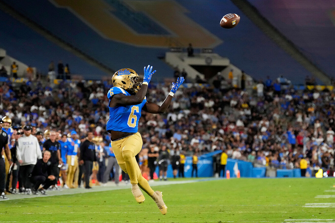 UCLA running back Anthony Woods makes a catch before running in for a...