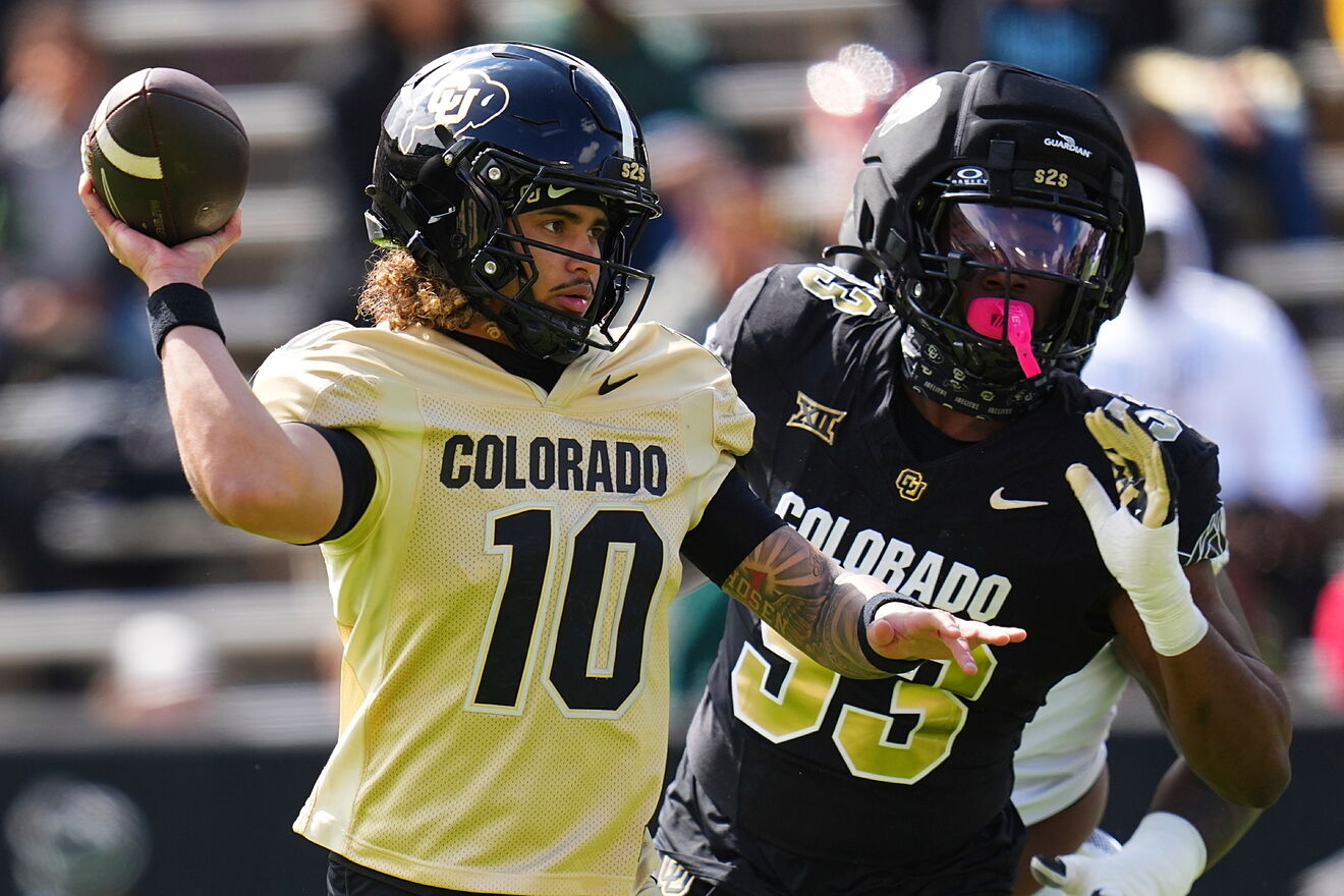 Colorado quarterback Julian Lewis (10) throws under pressure during...