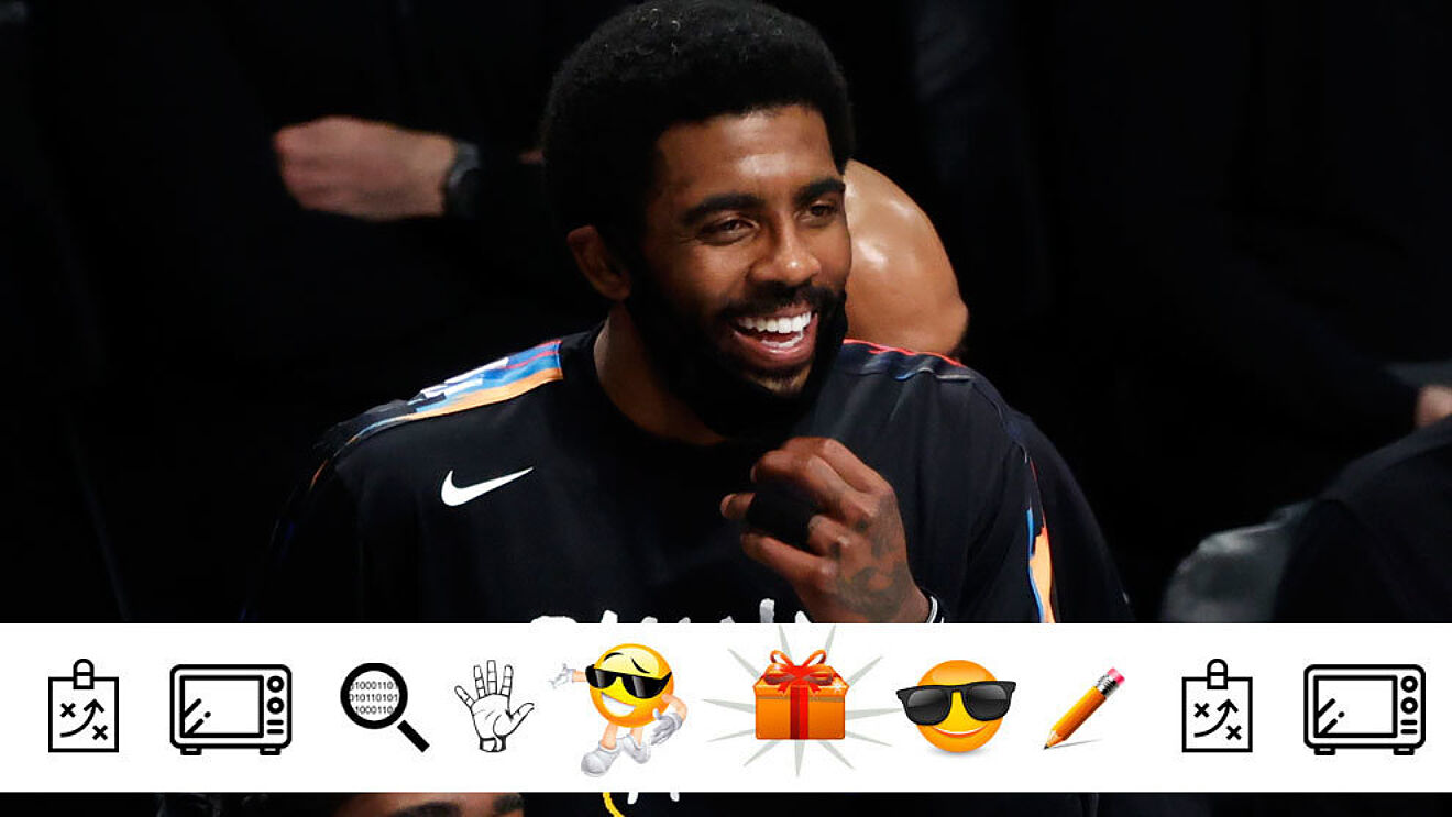 Kyrie Irving smiles on the Nets' bench