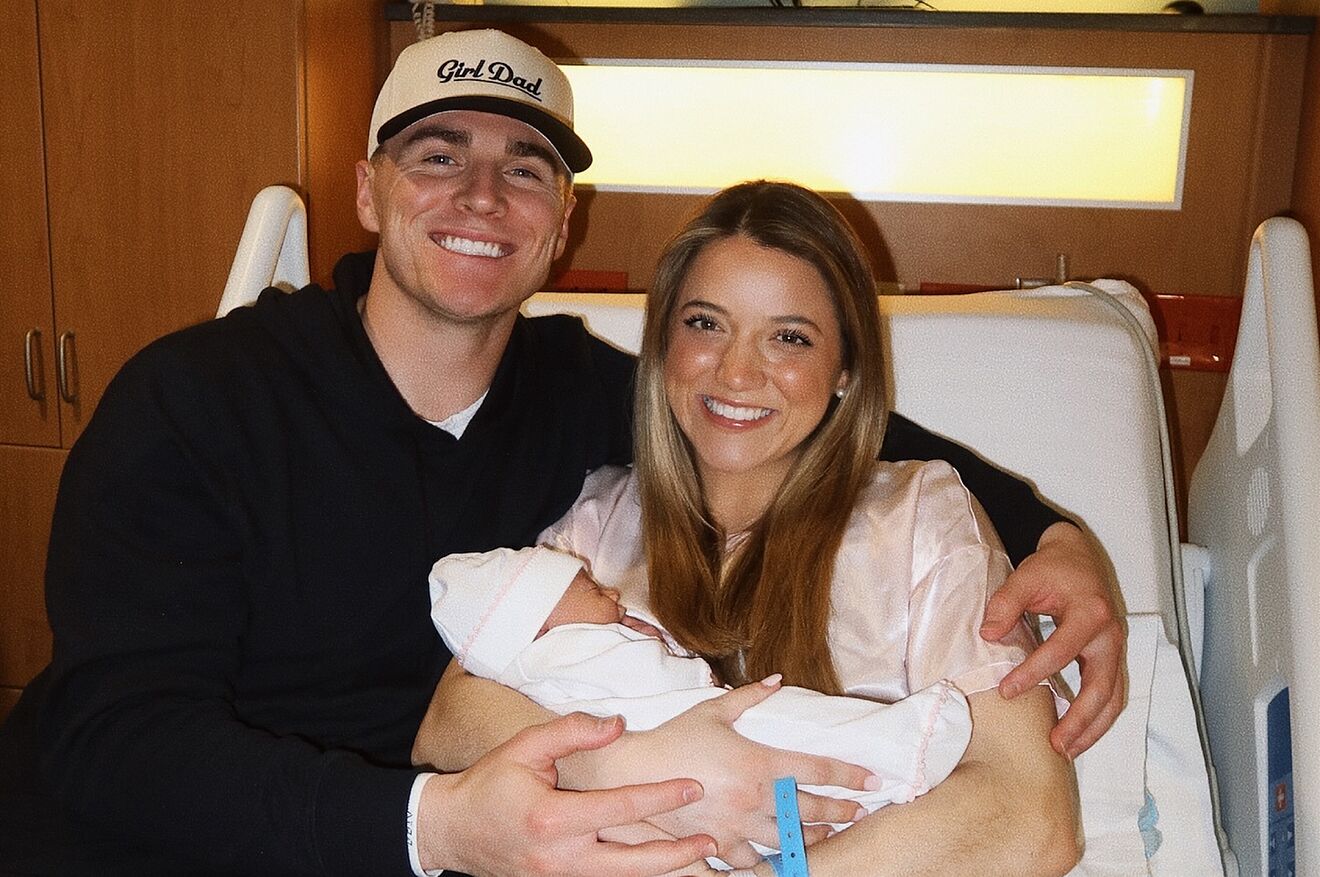 Bo Nix and his wife, Izzy, pose with their newborn daughter, Riley...