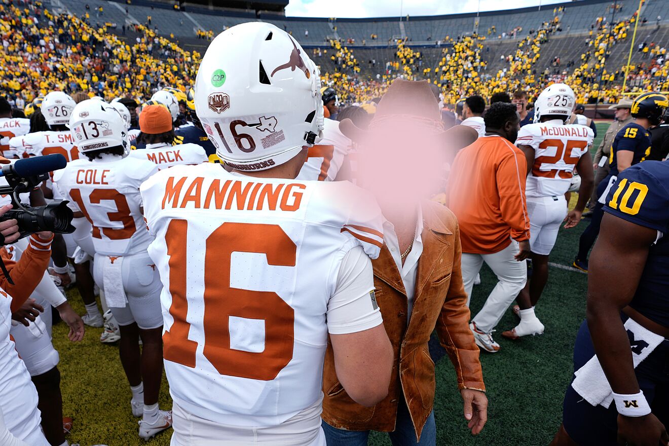 Arch Manning hugs Matthew McConaughy after Texas' win over Michigan.