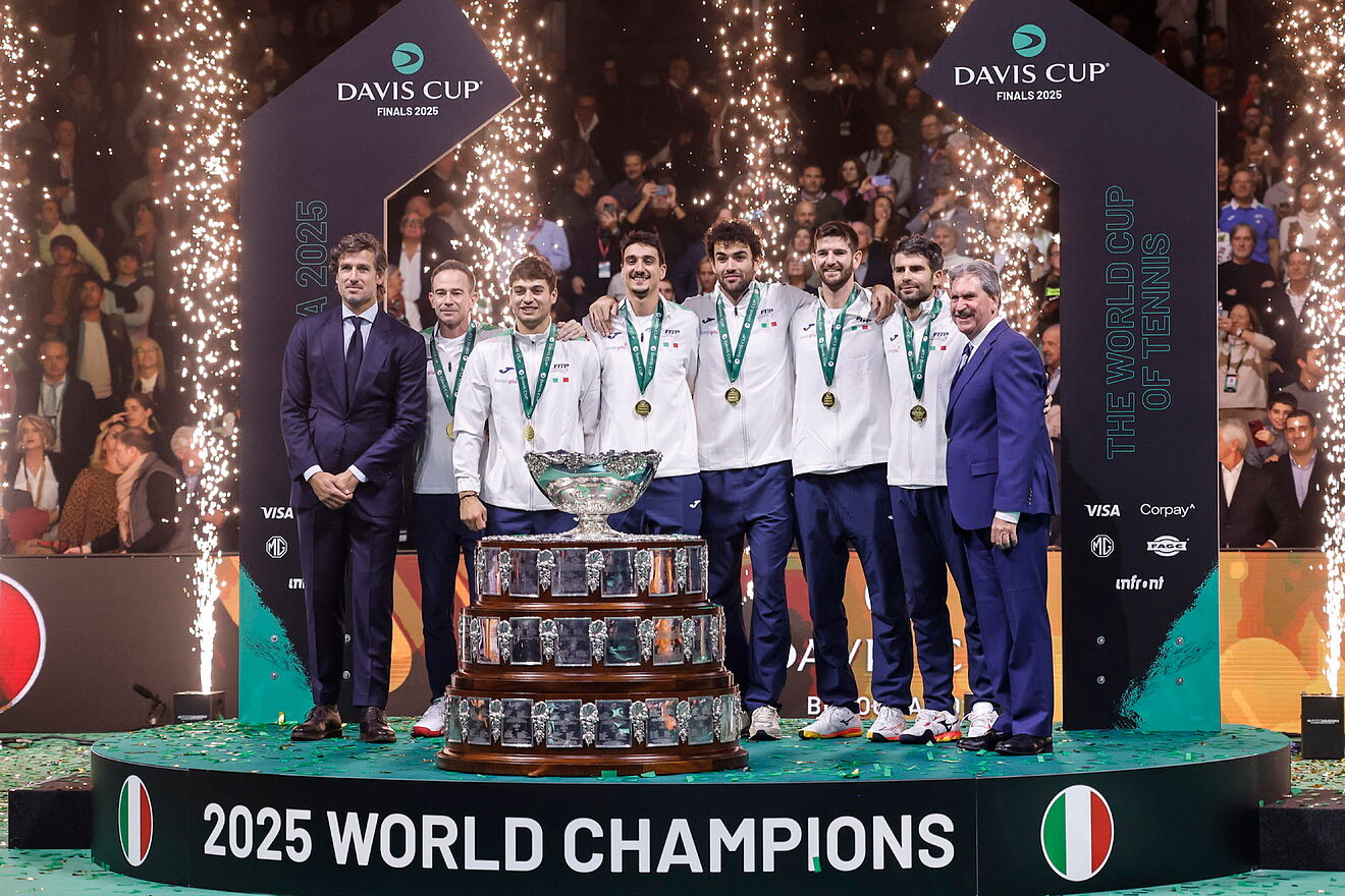 Italy's tennis team celebrates with the trophy after winning the Davis...