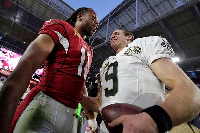 Arizona Cardinals wide receiver Larry Fitzgerald (11) greets New Orleans Saints quarterback Drew Brees (9) after an NFL football game