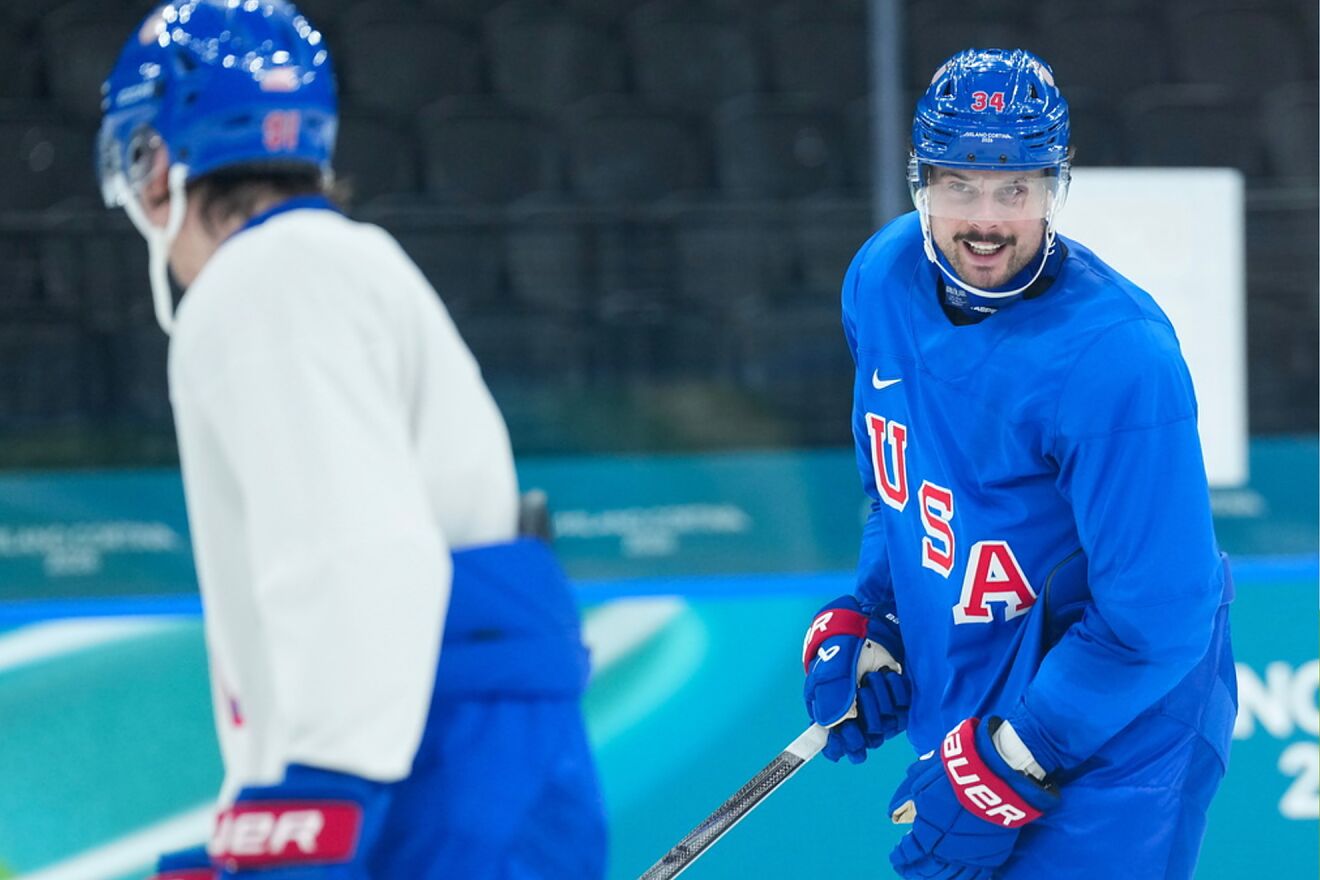 United States forward Auston Matthews, right, smiles as he takes part...