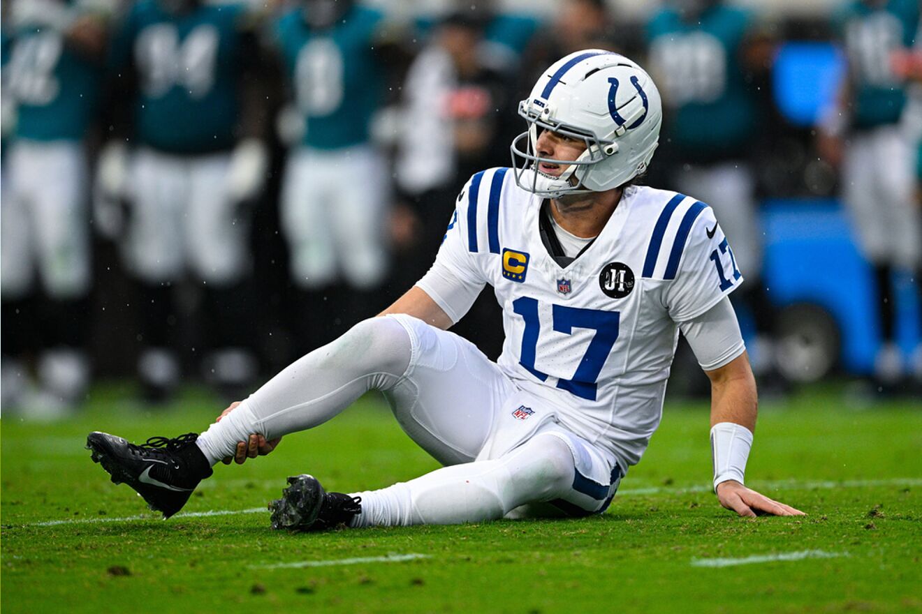 Indianapolis Colts quarterback Daniel Jones (17) grabs his leg after...