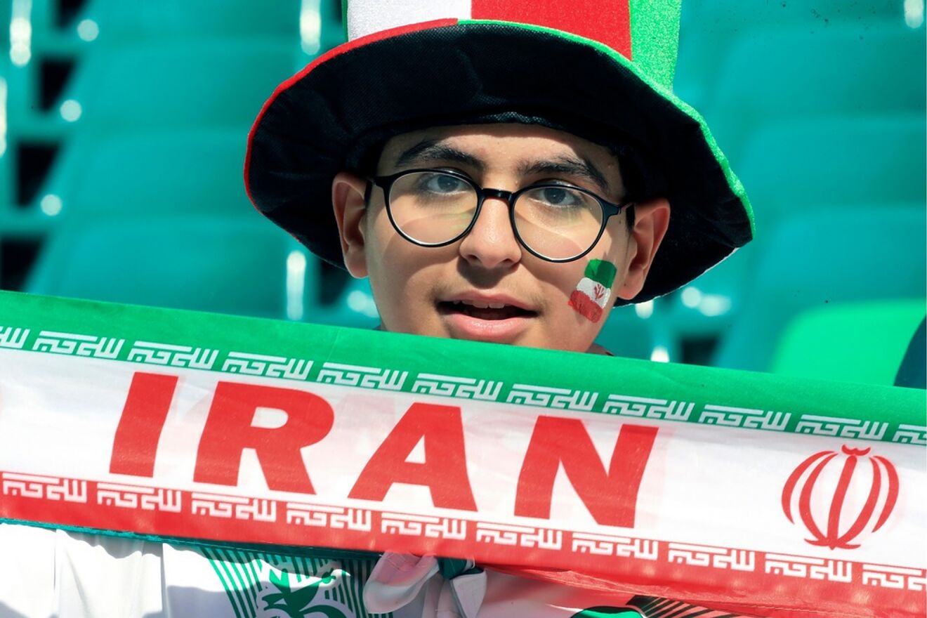 An Iranian fan holds his national team banner