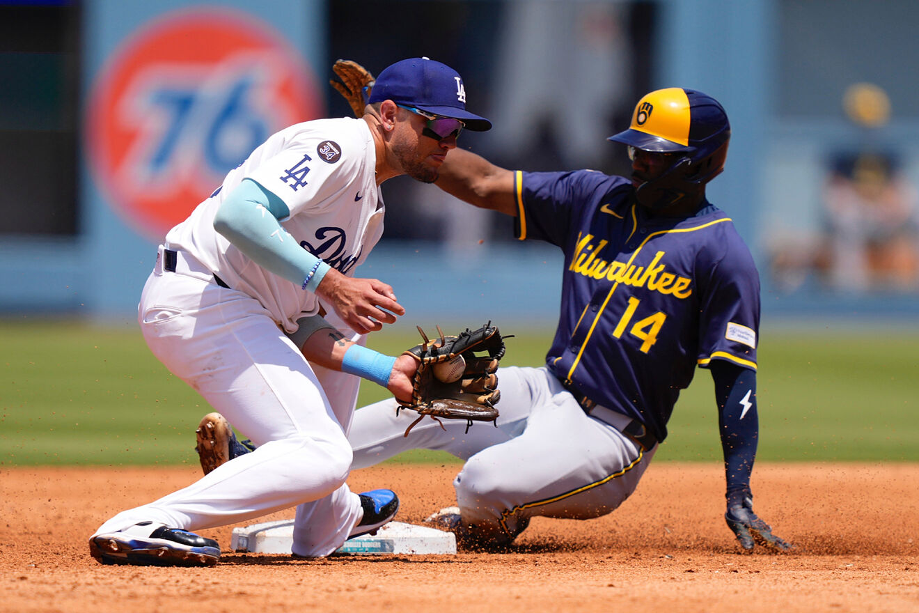 Milwaukee Brewers' Andruw Monasterio, right, slides into second while...