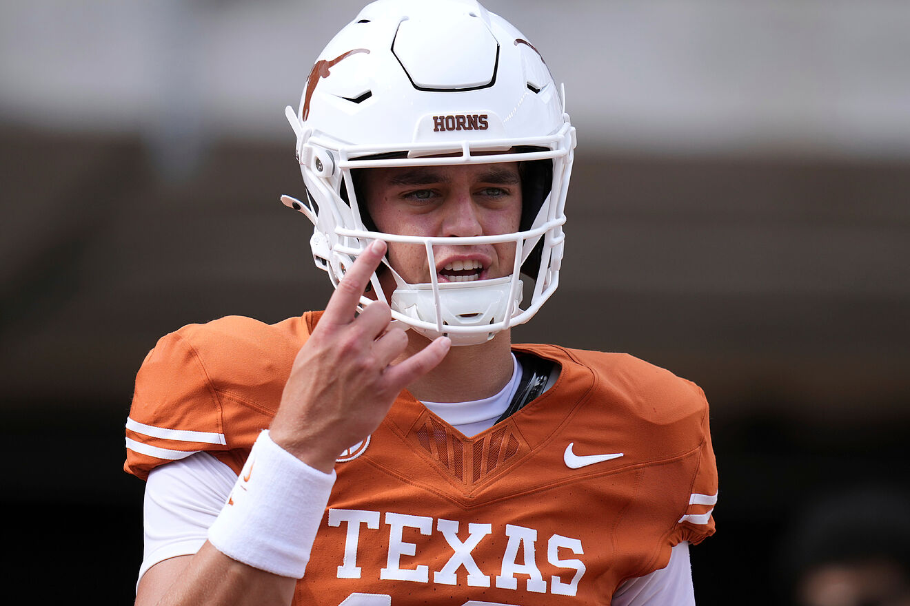 Texas quarterback Arch Manning warms up before an NCAA college...