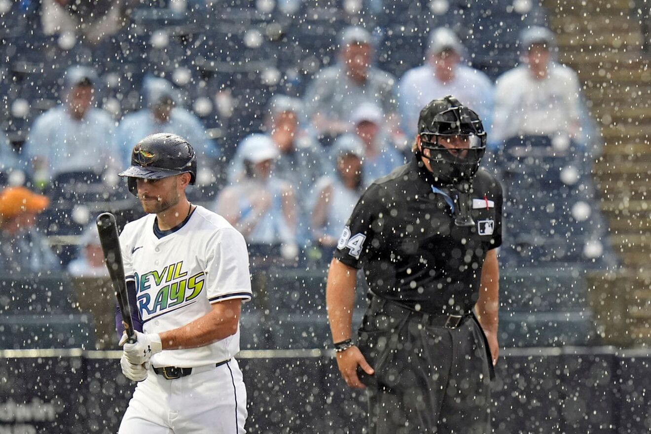 Tampa Bay Rays' Brandon Lowe, left, walks off the field after home...
