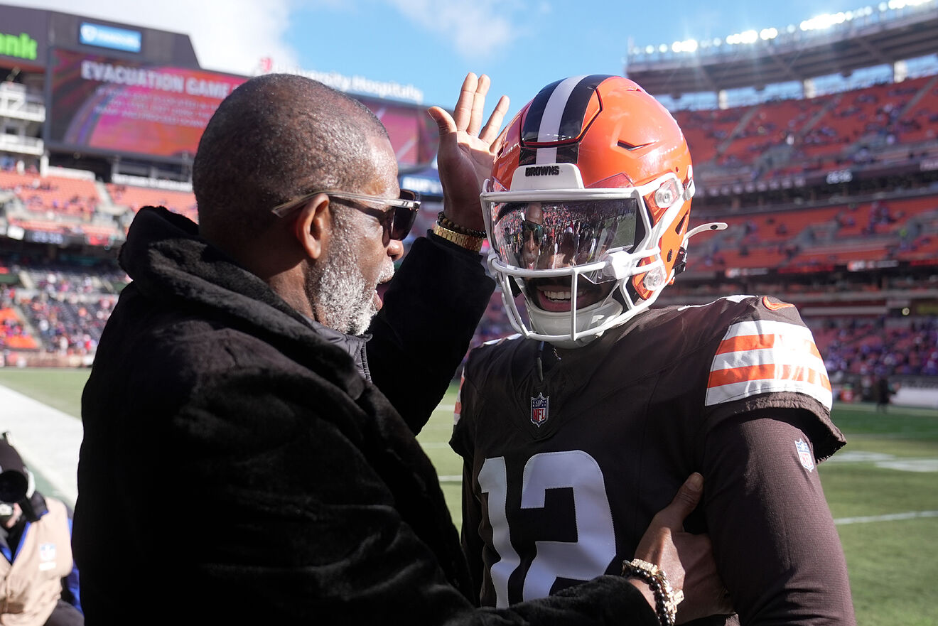 Deion Sanders greets his son, Shedeur Sanders, during a Cleveland...