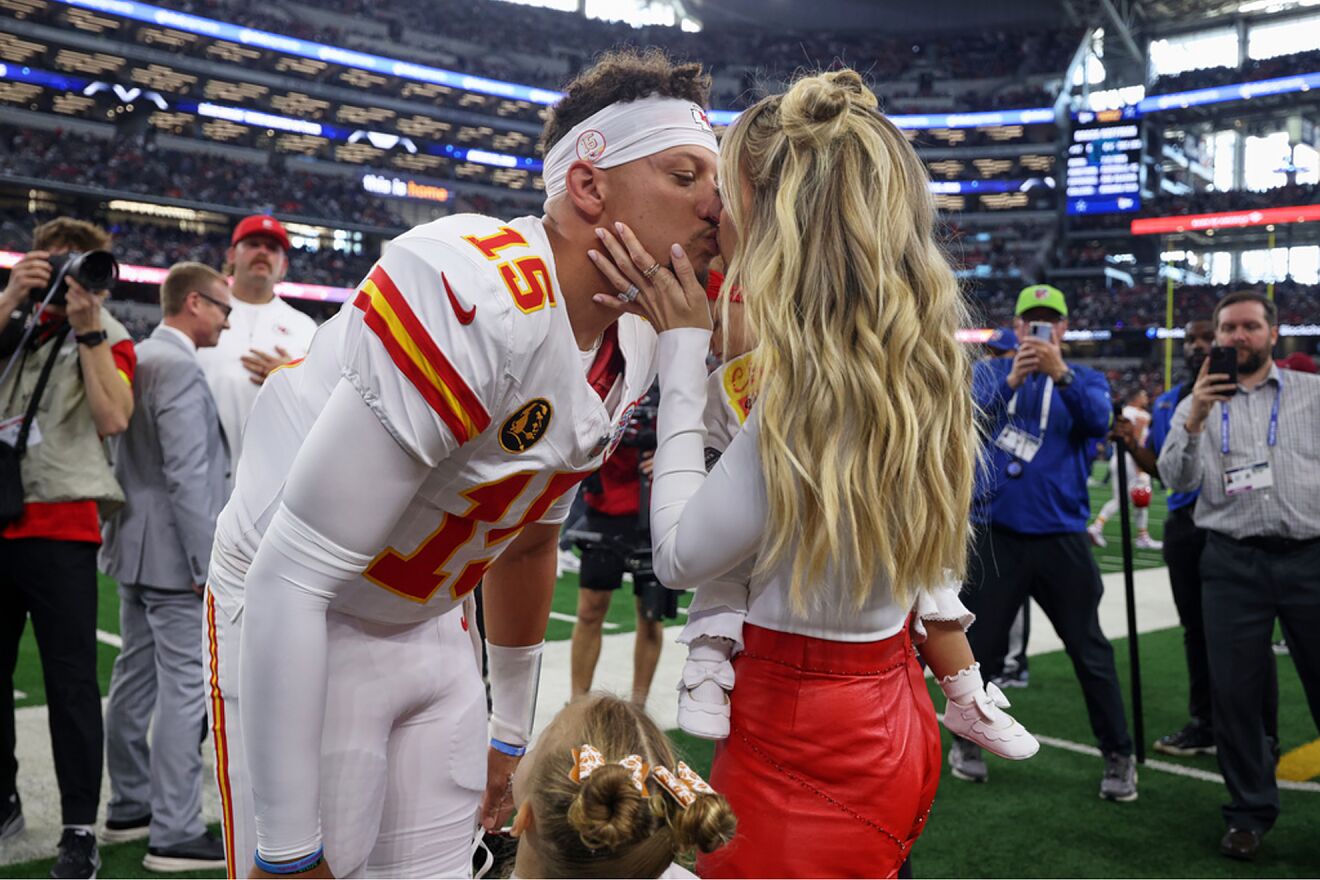 Kansas City Chiefs quarterback Patrick Mahomes (15) kisses his wife,...