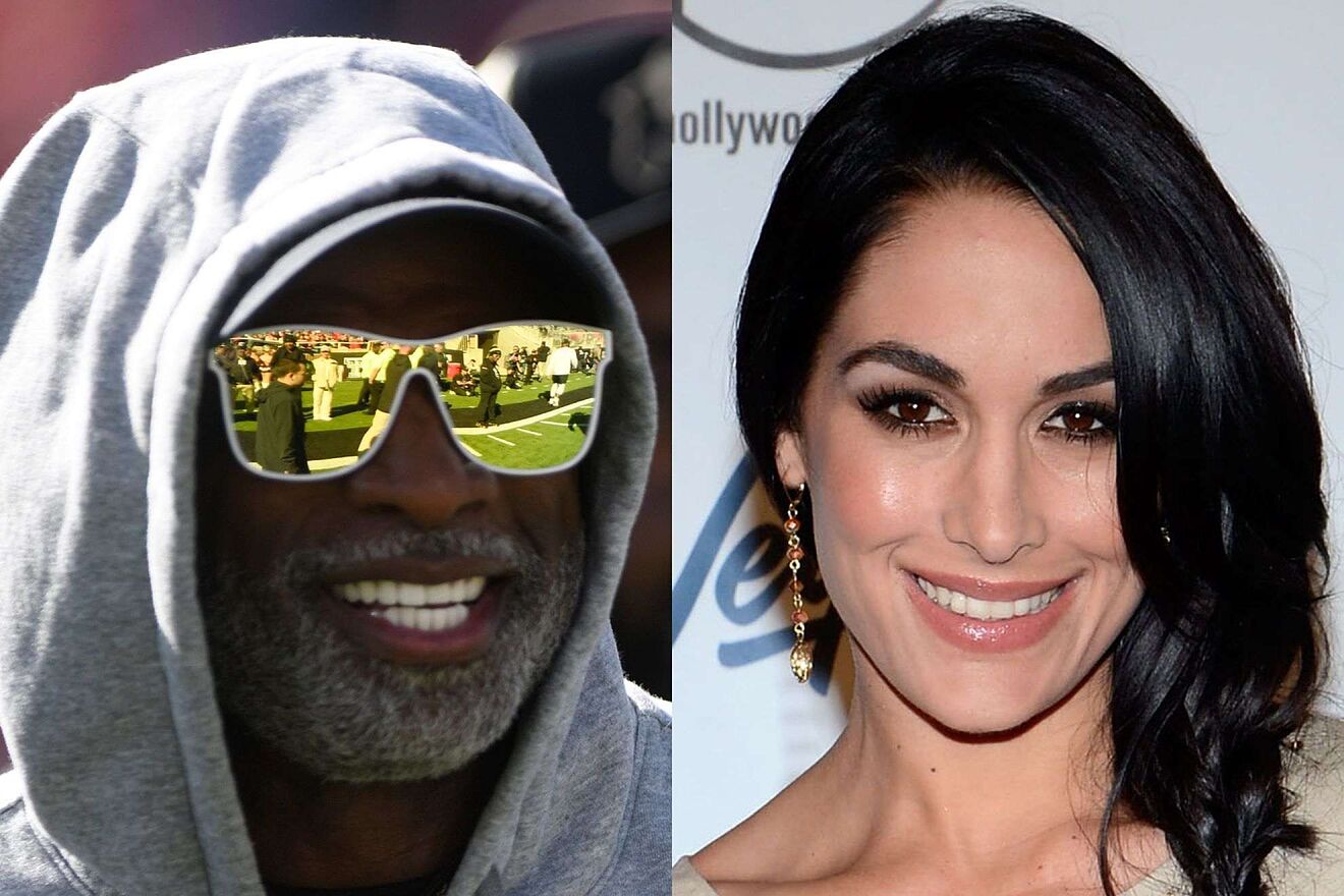 Deion Sanders gets up from his seat after Brie Bella reveals that he...