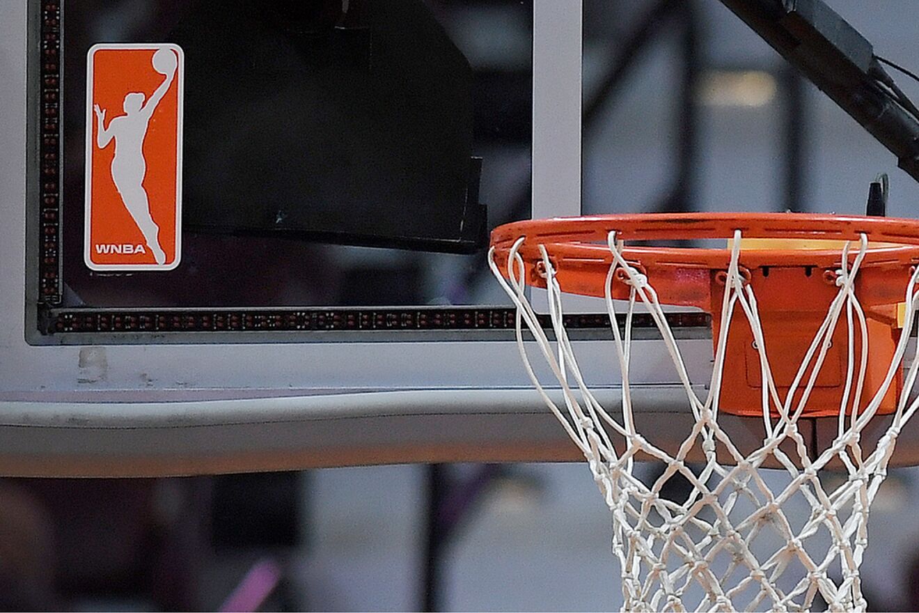 The WNBA logo is seen near a hoop