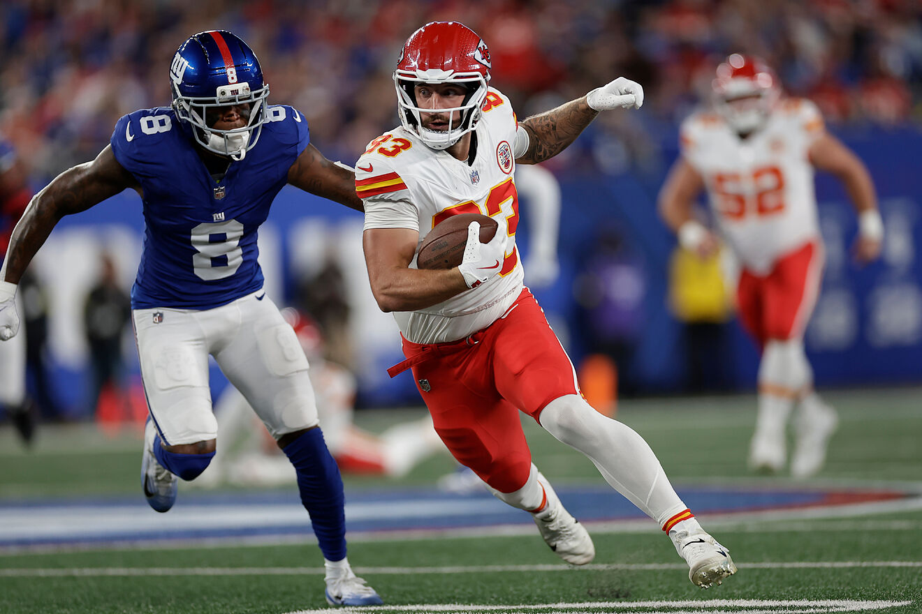 Kansas City Chiefs tight end Noah Gray runs past New York Giants...