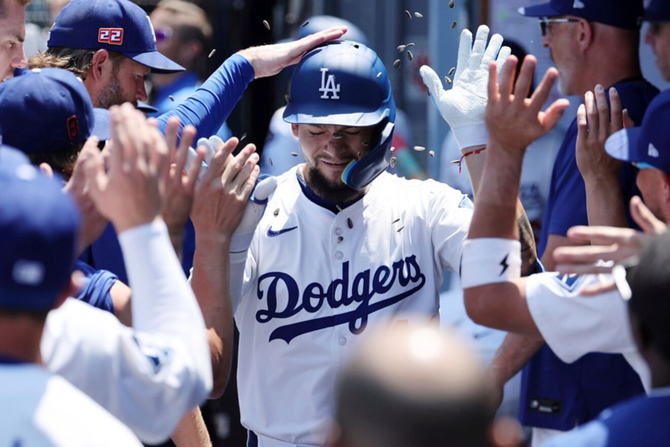Los Angeles Dodgers outfielder Andy Pages is congratulated in the...