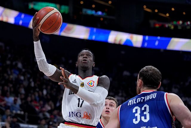 Germany guard Dennis Schroder shoots in front of Serbia center Nikola Milutinov