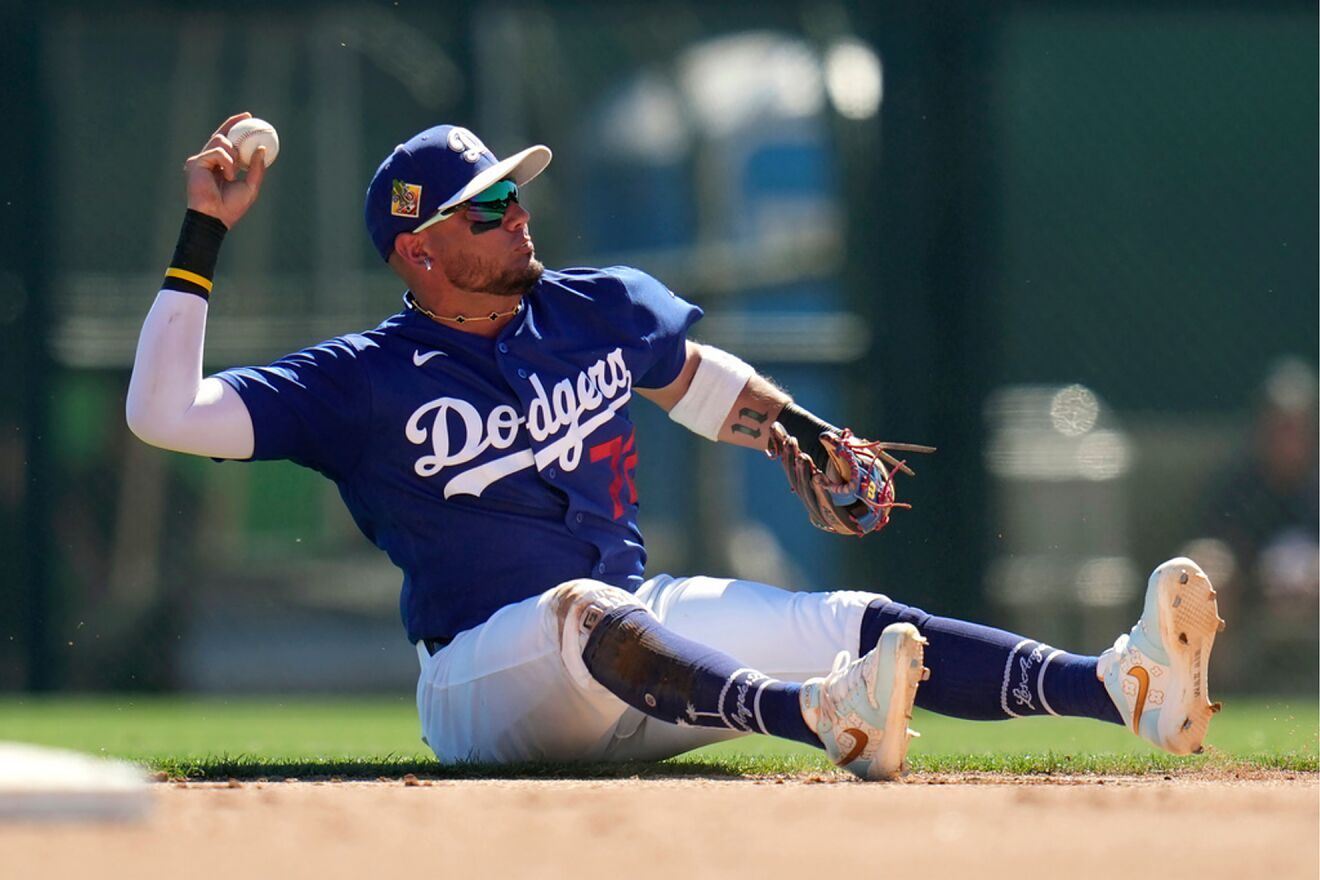 Los Angeles Dodgers second baseman Miguel Rojas throws to first base