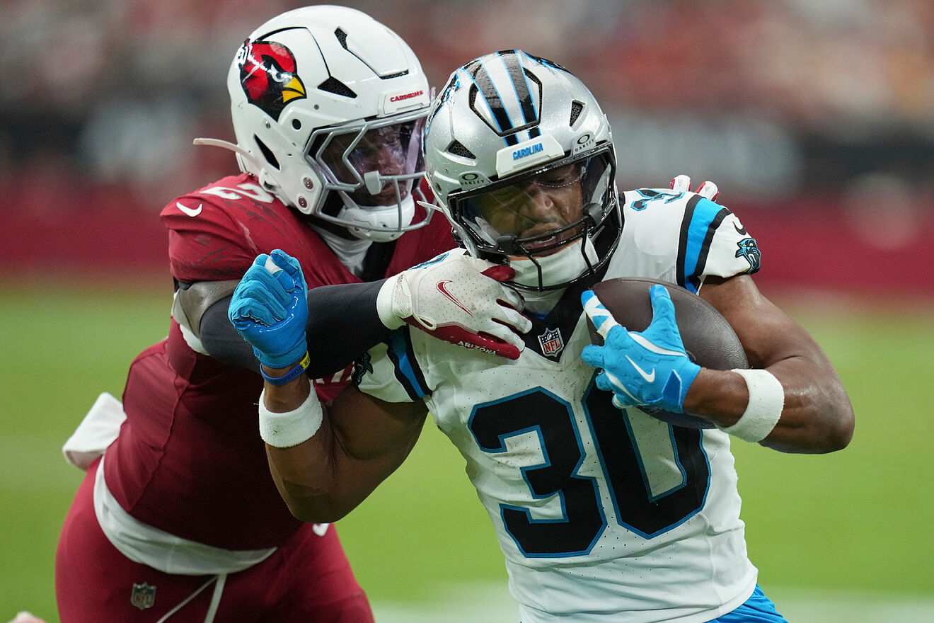Carolina Panthers running back Chuba Hubbard is tackled by Arizona...