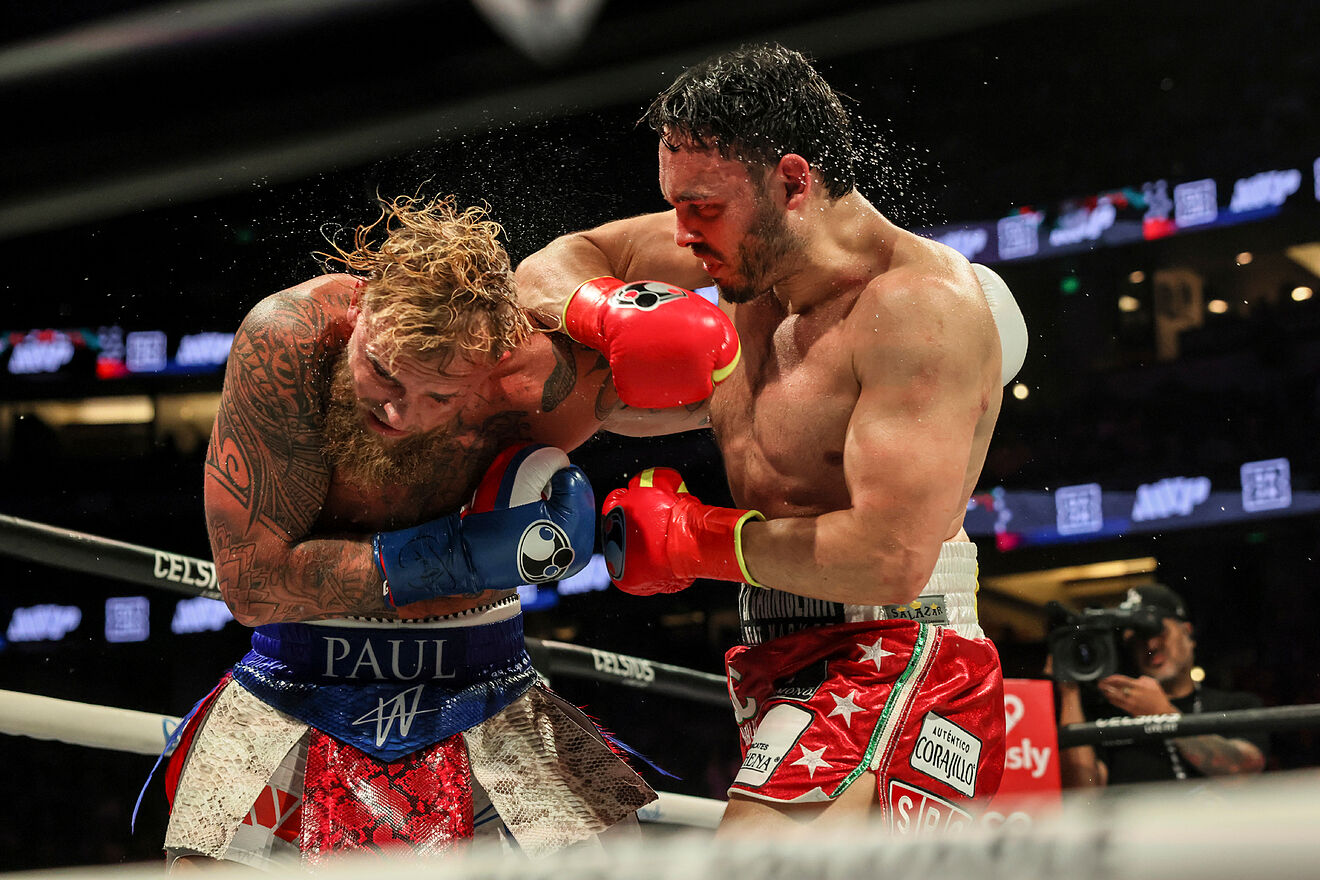 Julio Cesar Chavez Jr., right, punches Jake Paul during their...