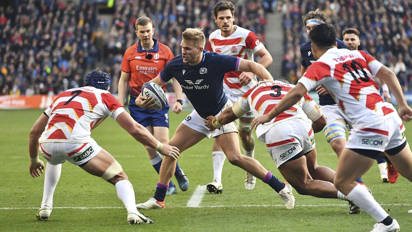 Scotland's Chris Harris, center, tries to break through the Japanese...