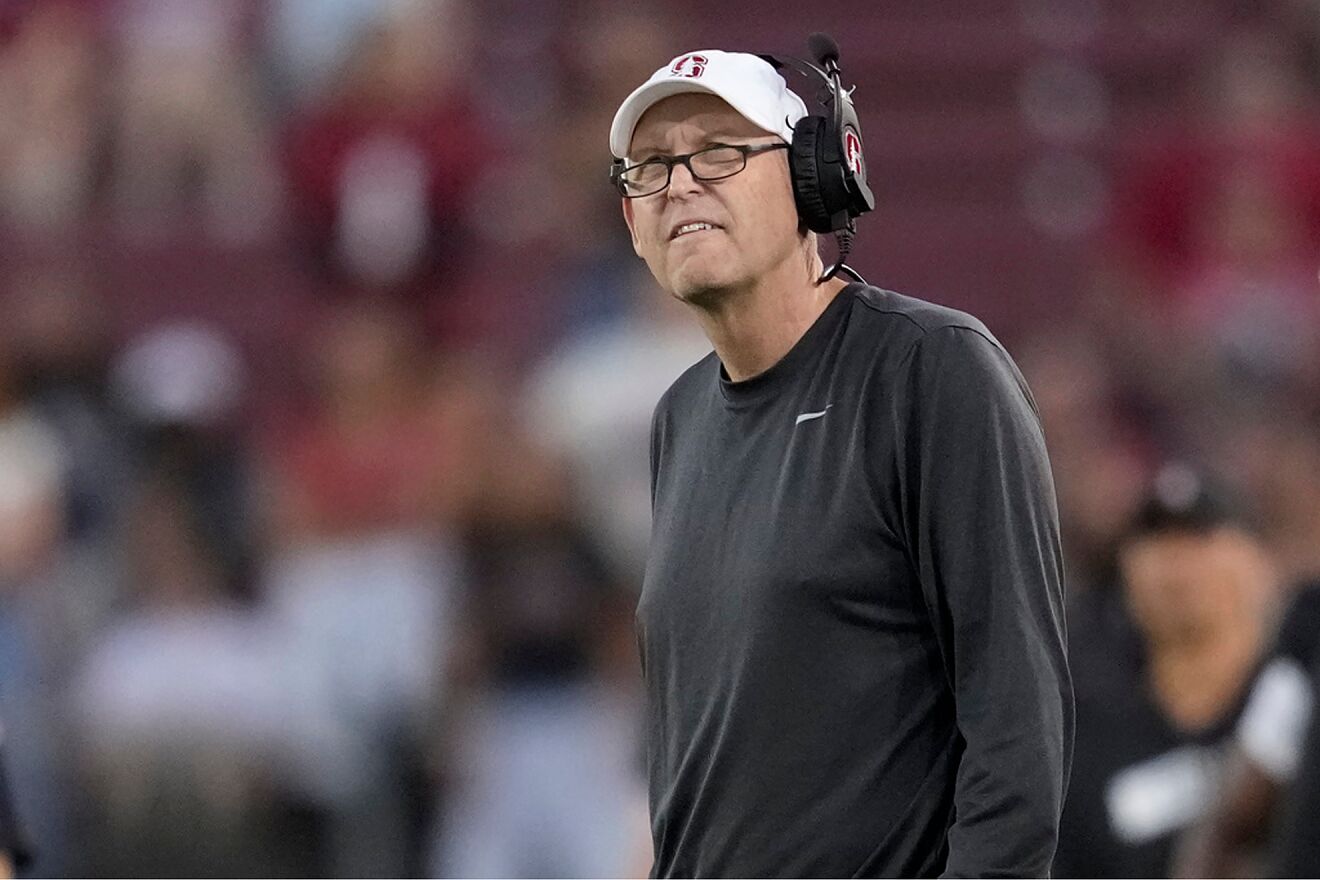 Former Stanford head coach Troy Taylor reacts as he watches the video...