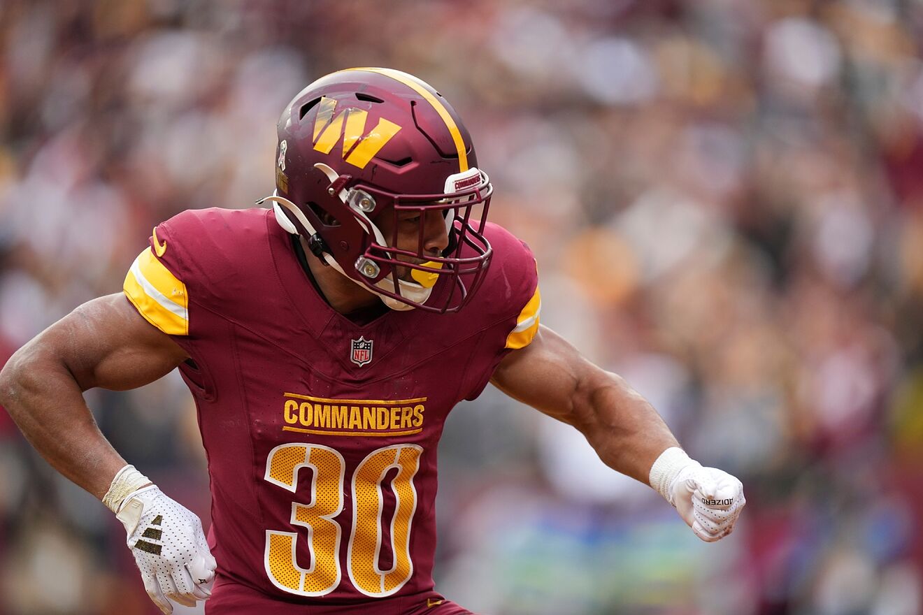 Washington Commanders running back Austin Ekeler reacts after his...