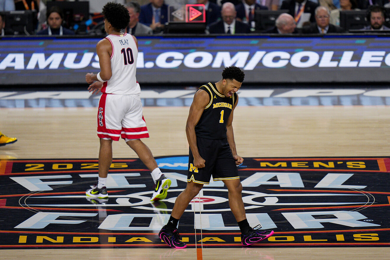 Michigan guard Trey McKenney (1) celebrates his basket against Arizona...