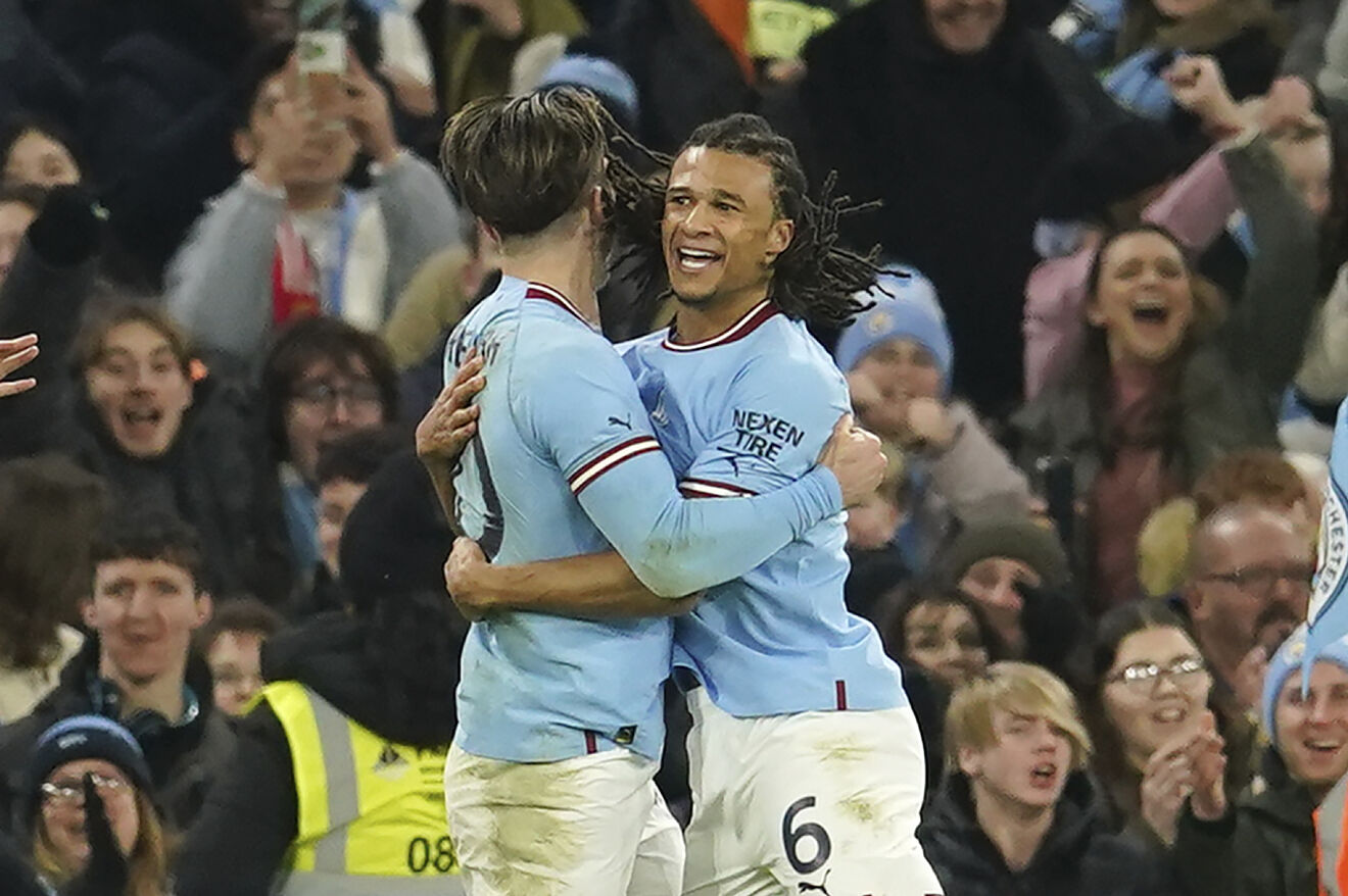 Manchester City's Nathan Ake, right, celebrates with his teammate Jack...