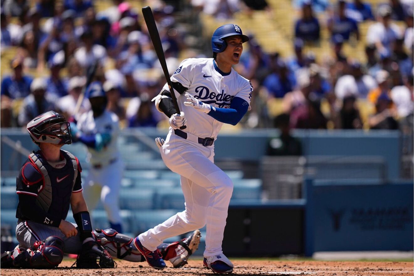 Los Angeles Dodgers' Shohei Ohtani, right, yells spatter hitting a...