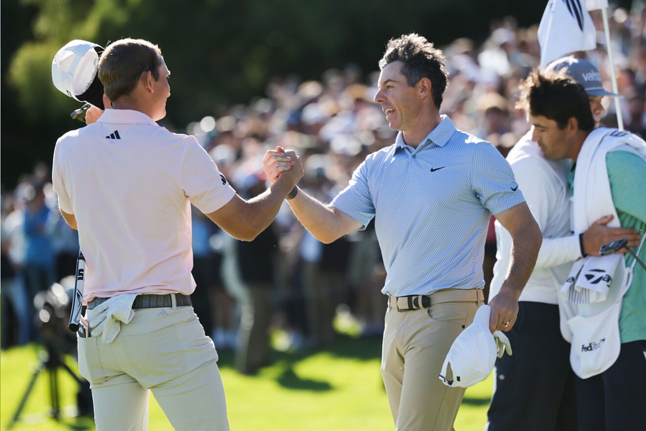 Jacob Bridgeman, left, shakes hands with Rory McIlroy