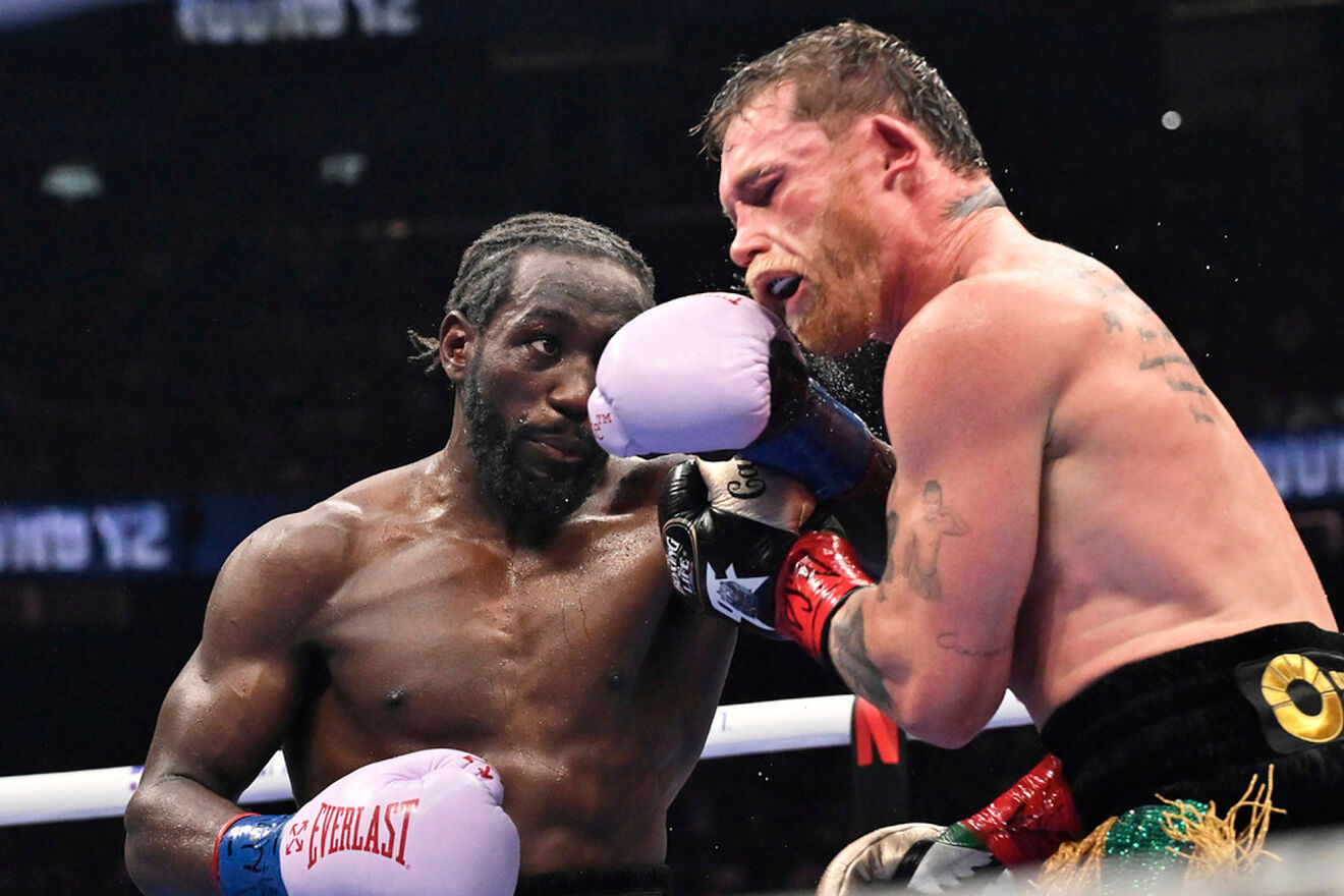 Terence Crawford, left, punches Canelo Alvarez