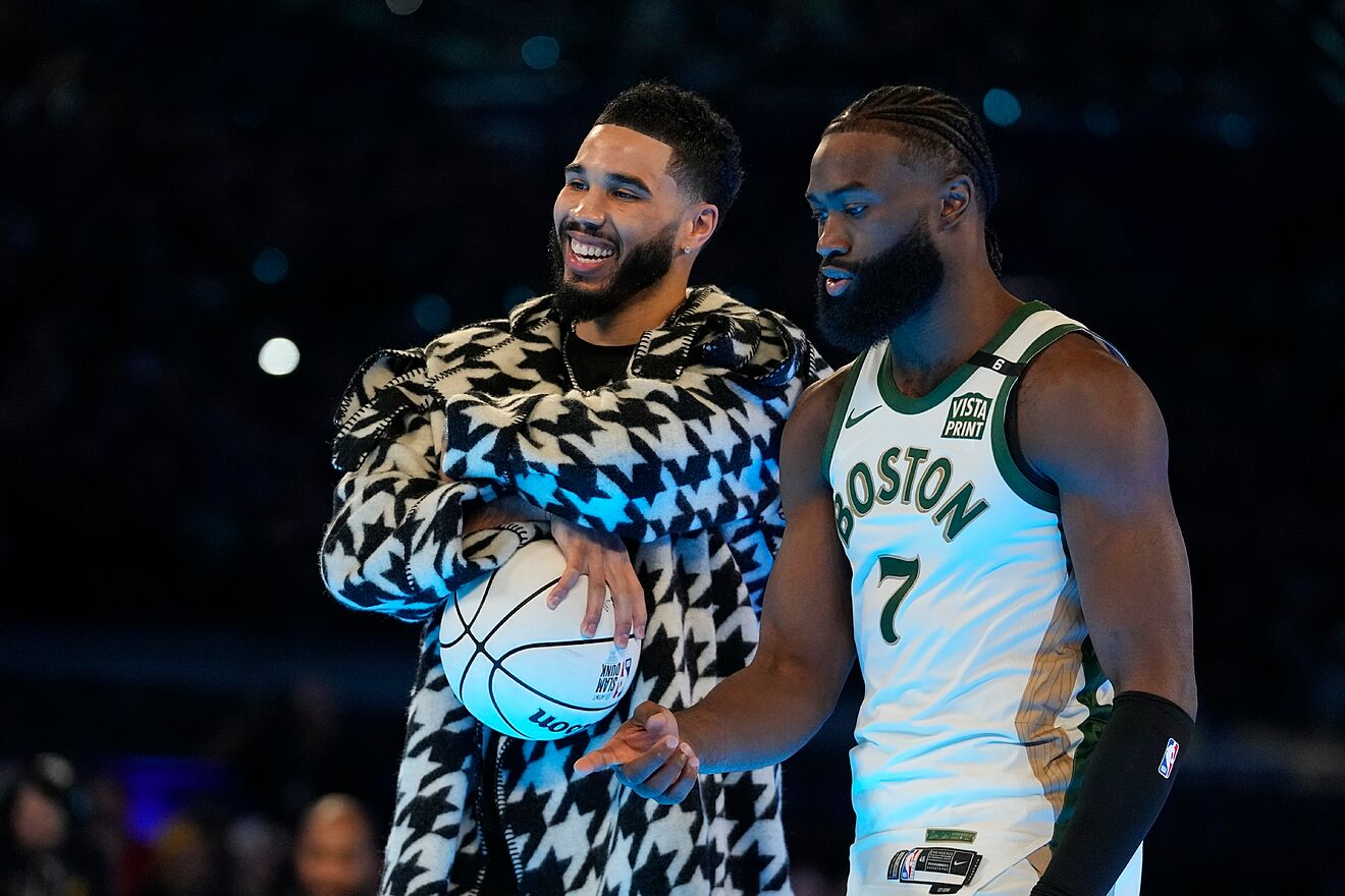 Boston Celtics' Jaylen Brown (7) talks with Jayson Tatum during the...