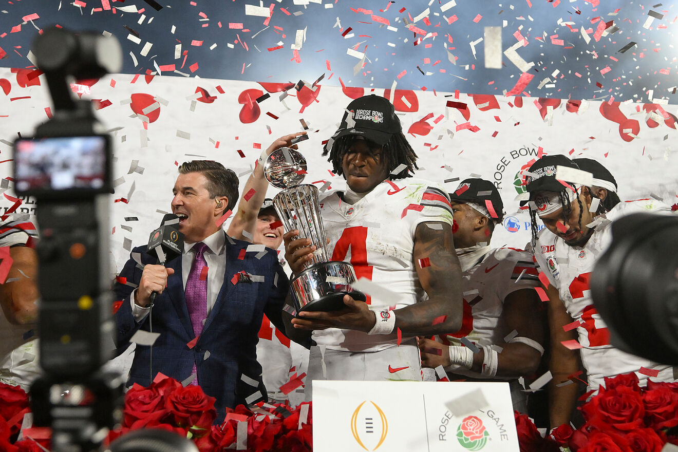 Ohio State wide receiver Jeremiah Smith (4) holds the trophy as he...