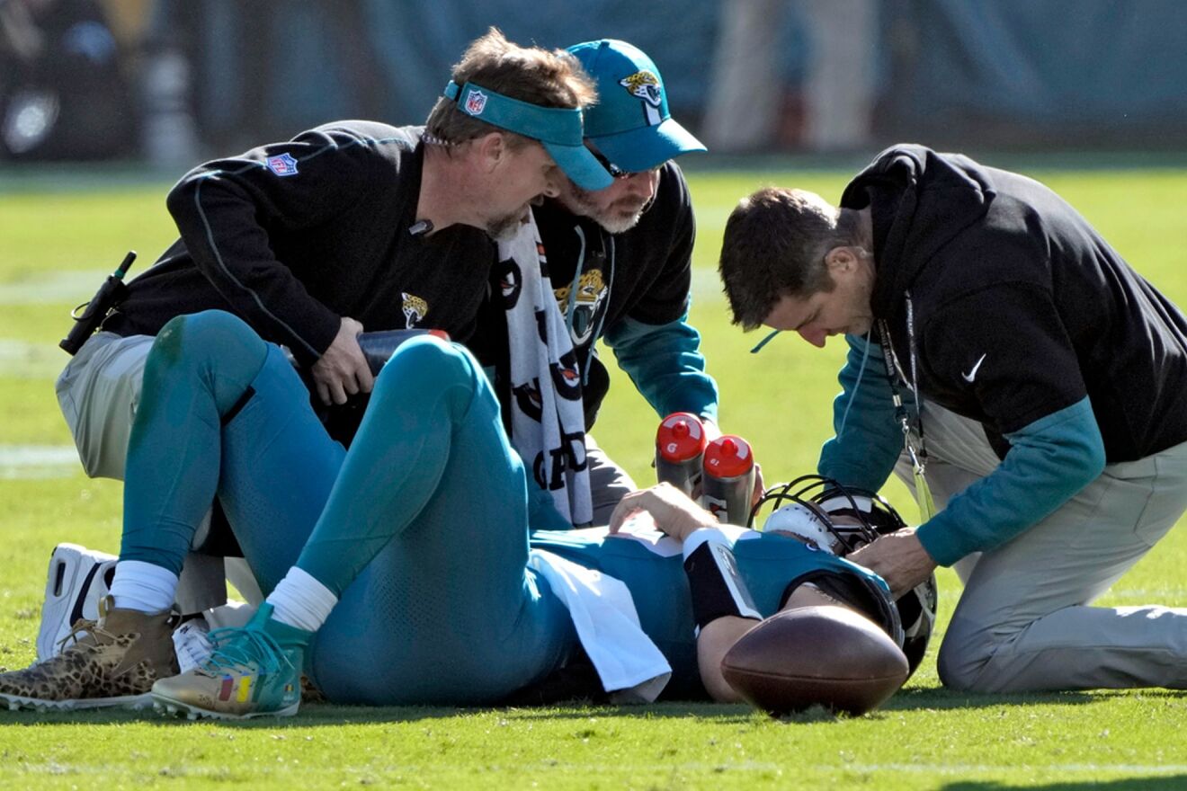 The Jaguars medical staff tending to Trevor Lawrence after Azeez...