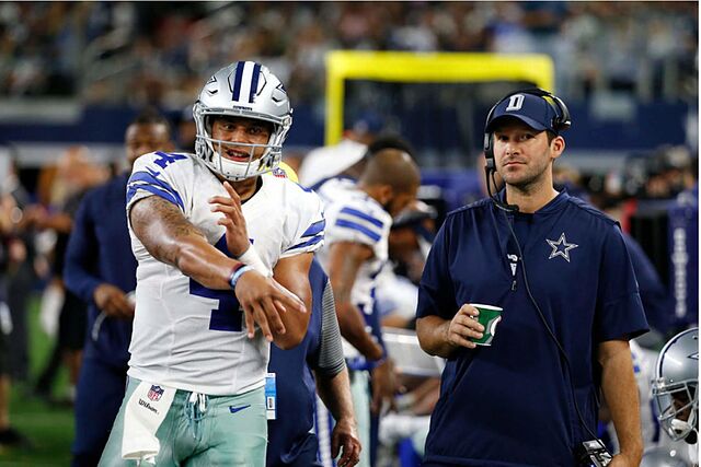 Dak Prescott practices on the sideline next to former Cowboys QB Tony Romo.