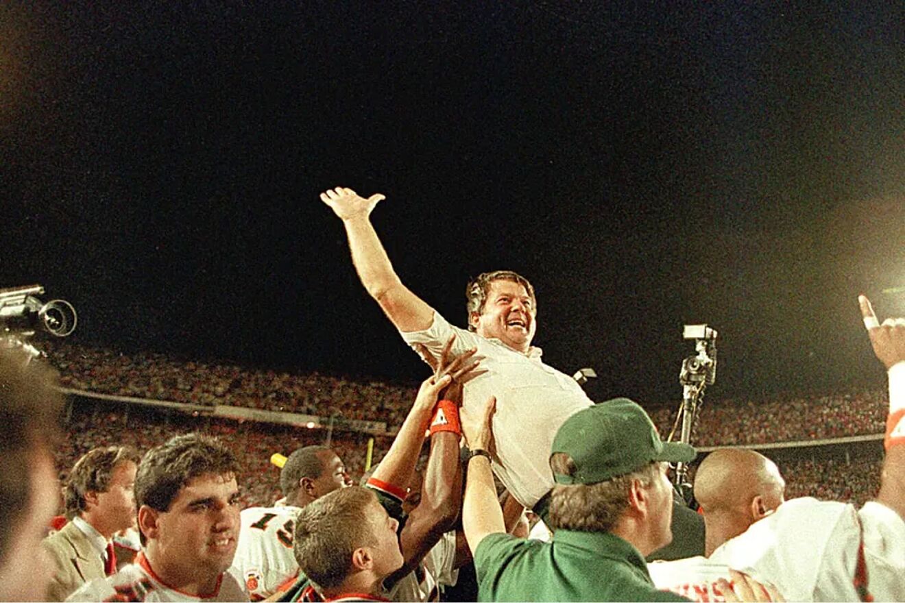 University of Miami coach Jimmy Johnson is carried from the field by...