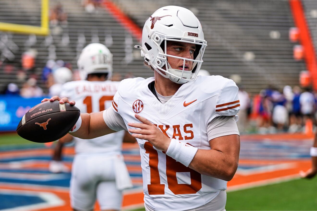 Texas quarterback Arch Manning warms up before an NCAA college...