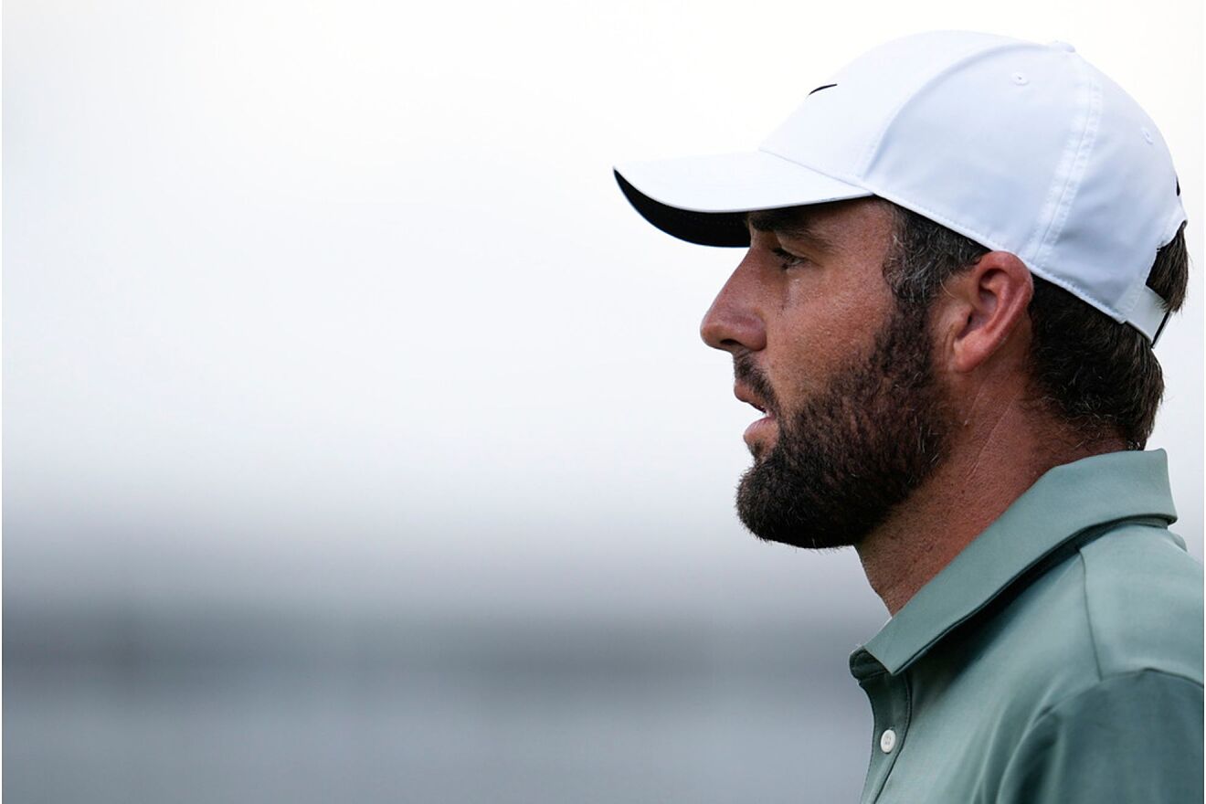 Scottie Scheffler walks on the 16th hole during the final round of the...
