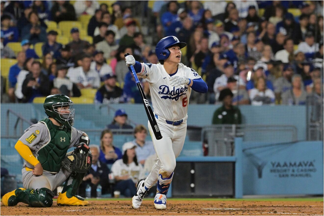 Los Angeles Dodgers' Hyeseong Kim follows through on his first career...