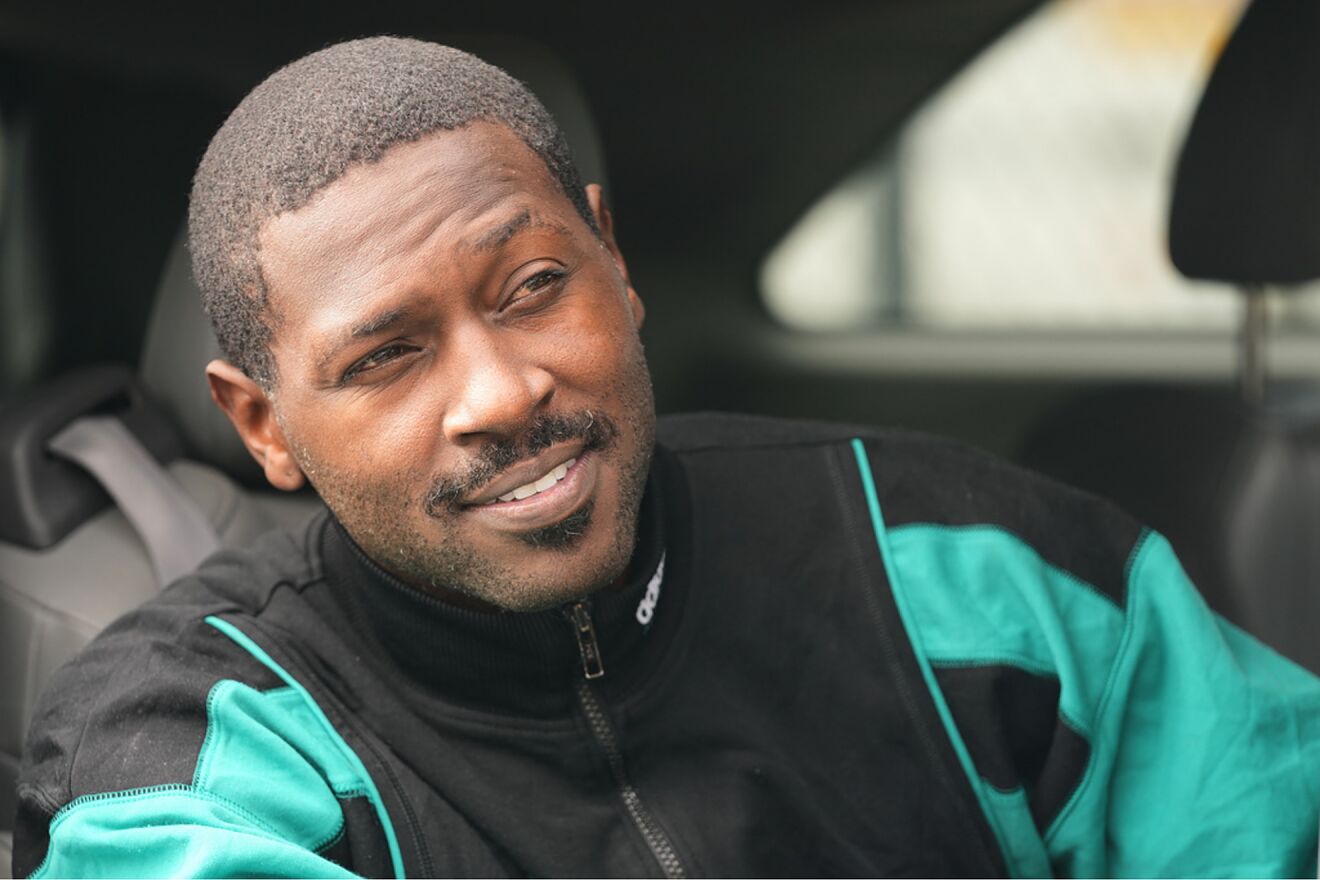 Former NFL star wide receiver Antonio Brown smiles from a vehicle...