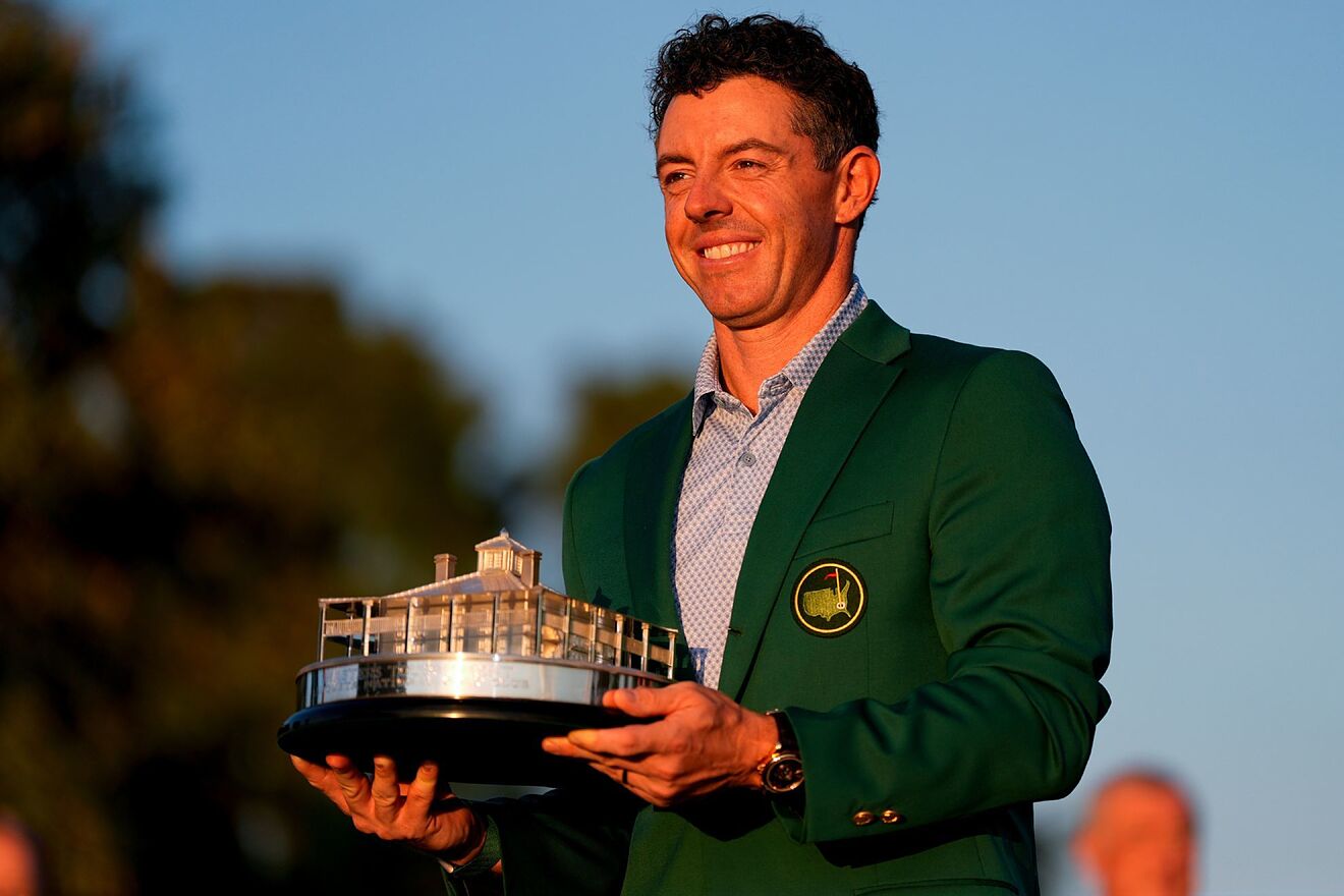 Rory McIlroy, of Northern Ireland, holds the trophy after winning the...