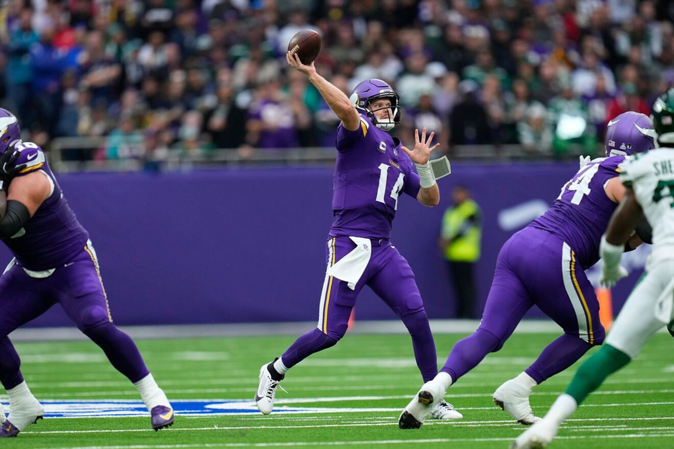 Vikins' Sam Darnold throws during the first half of an NFL football...